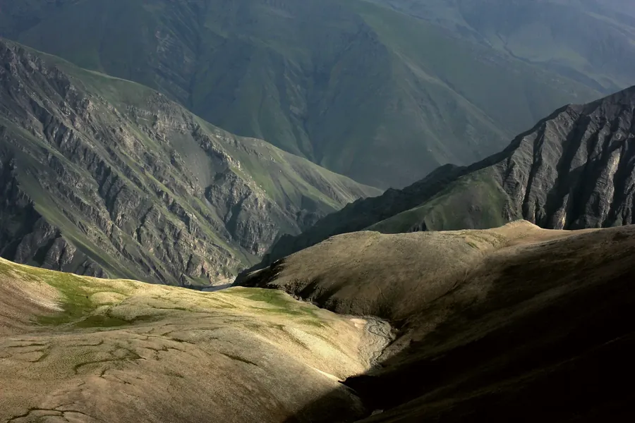 Green ridges running back into haze below the Shahdag massif.