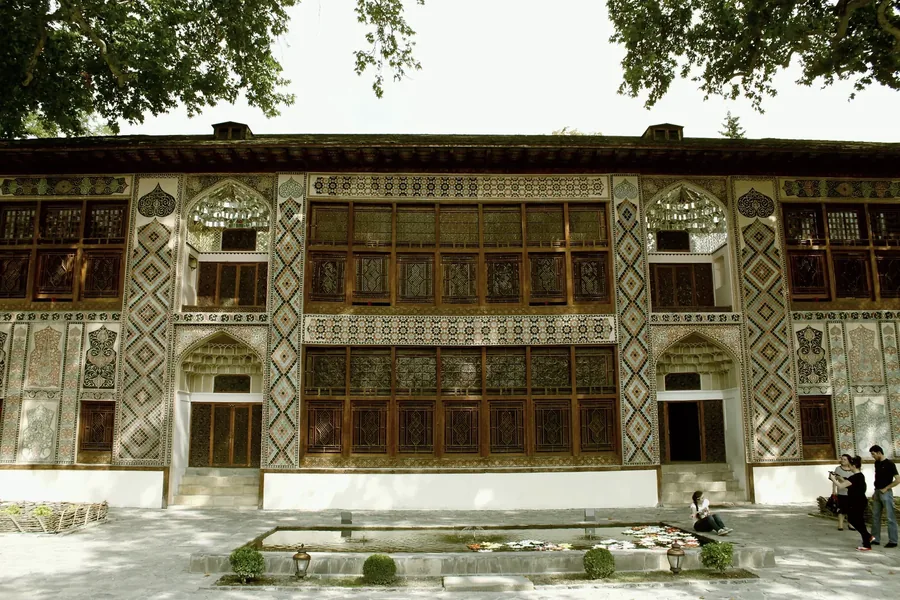 The painted facade and latticed windows of the Khan's Palace at Sheki.